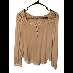 A cream colored see thru Junior medium size top. Has never been worn.